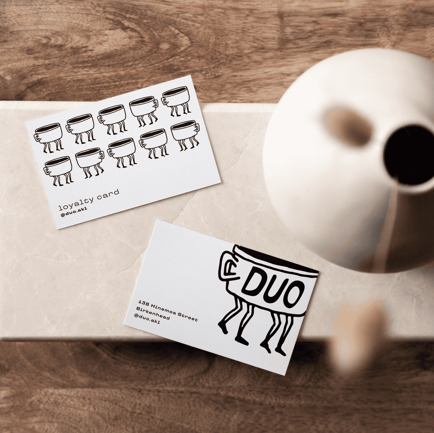 Duo coffee cards next to a cute vase