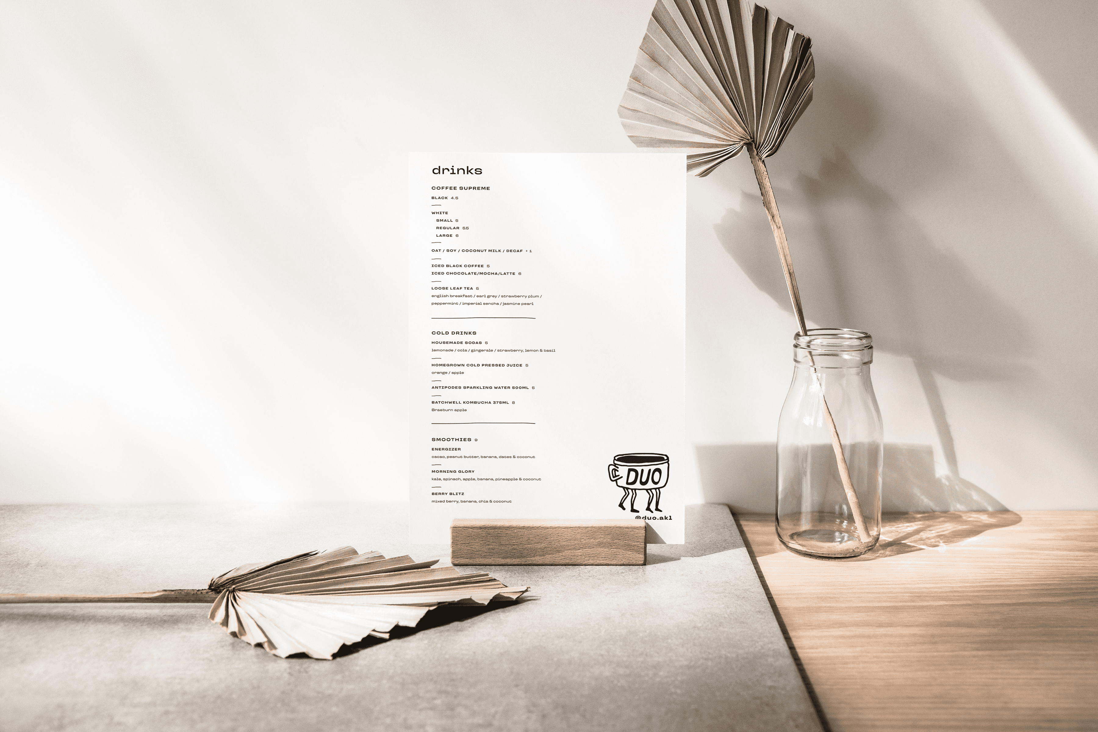 Duo menu display with dried palm leaves and sunlight